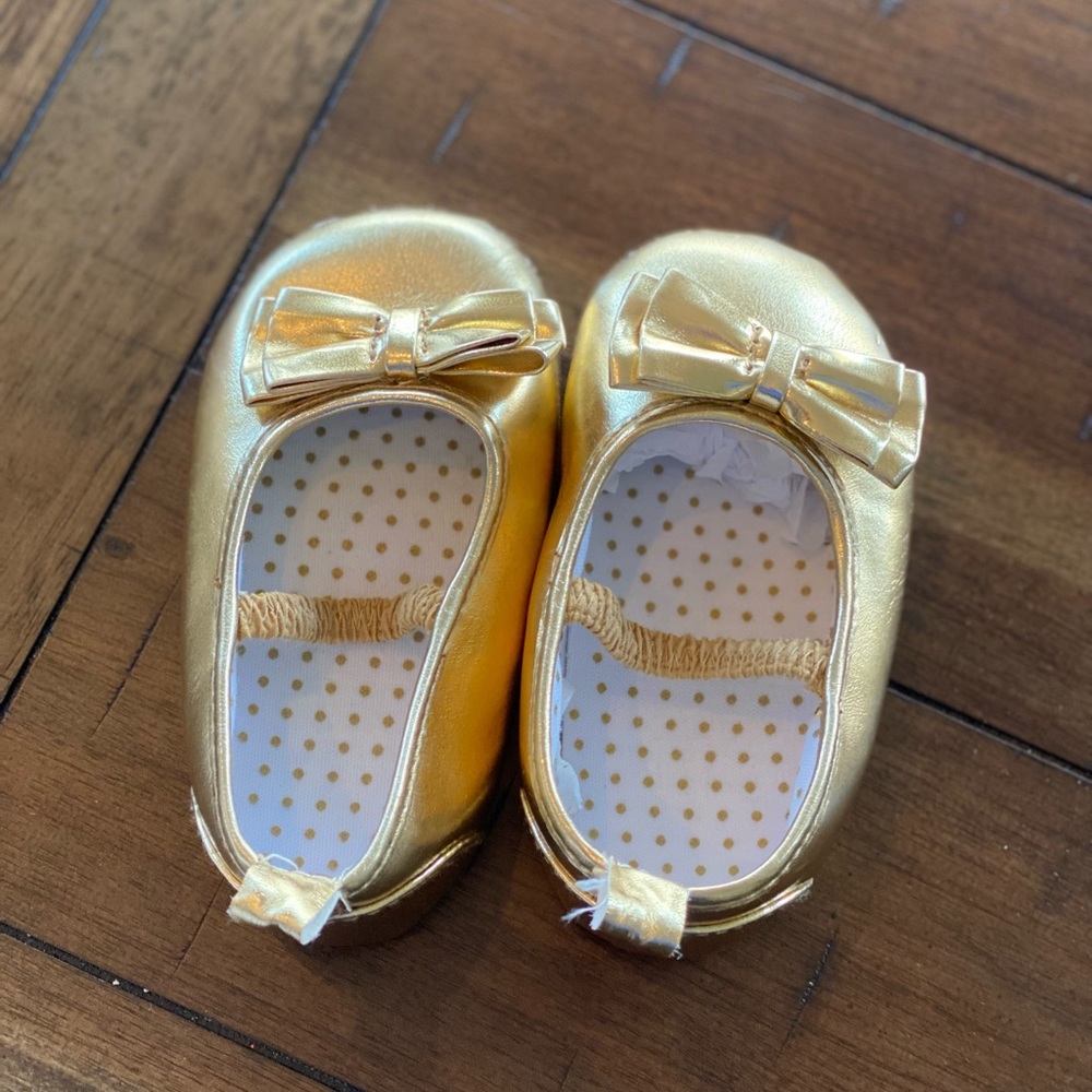 Gold colored, baby shoes